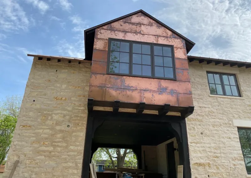 Copper metal panel facade on a stone building for Skylight Installation in St. Charles
